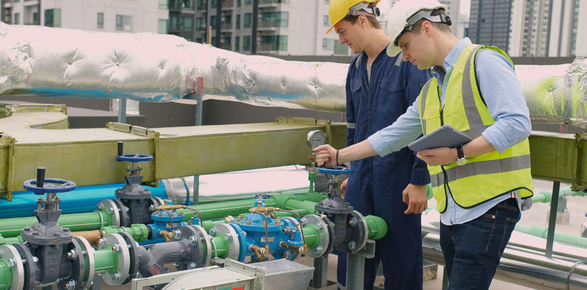 Tradesmen checking a valve