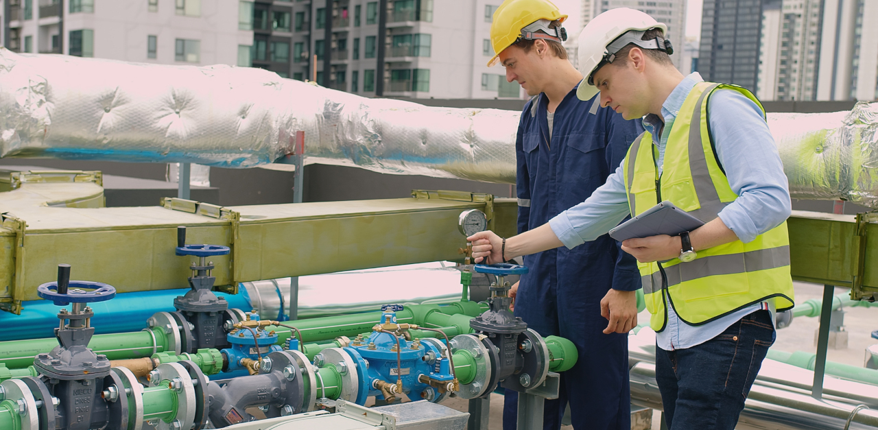 Tradesmen checking a valve